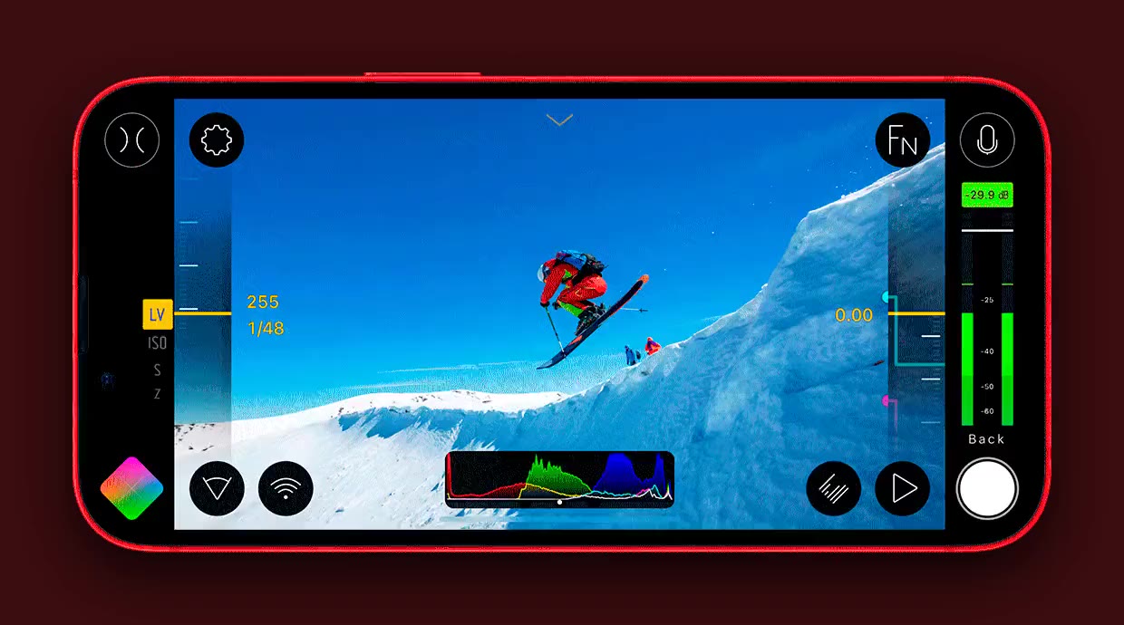 Filmic Pro camera interface on a phone, filming a skier mid-jump with focus, exposure and audio controls