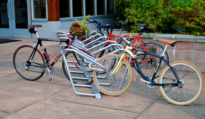 Sportworks Plaza bike rack outside a building, holding several bikes